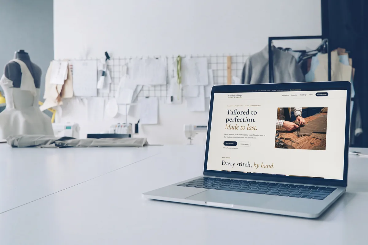 The Ward & Selvage concept website on a laptop on a tailor's worktable